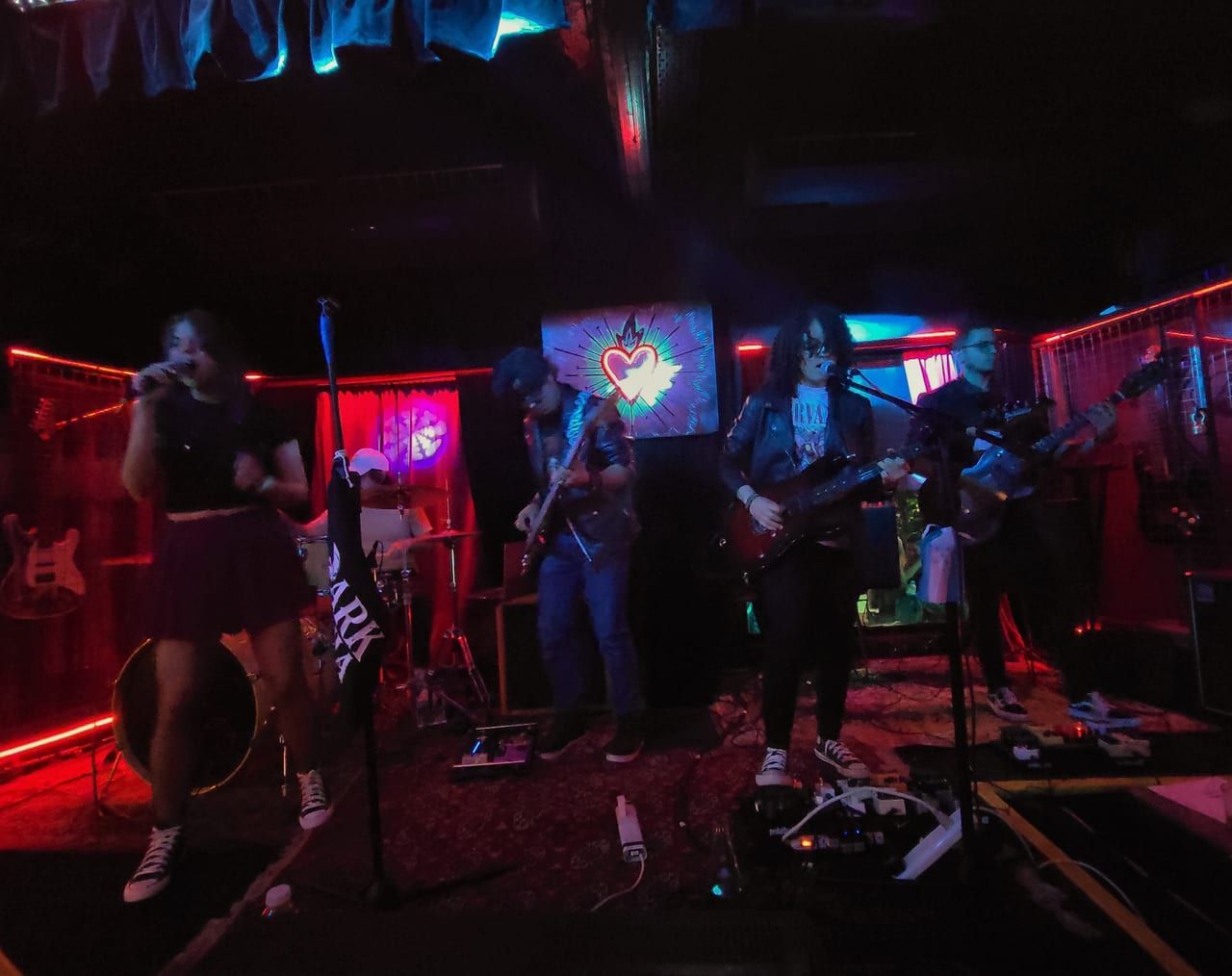 Darkmenia playing live in Argentina with neon lights